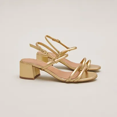 Heeled sandals in gold metallic leather