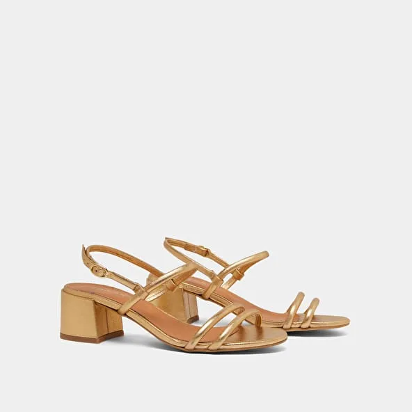 Heeled sandals in gold metallic leather