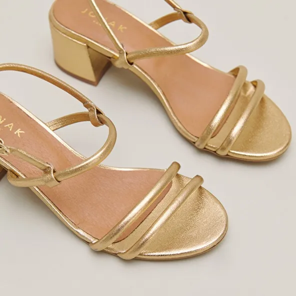 Heeled sandals in gold metallic leather