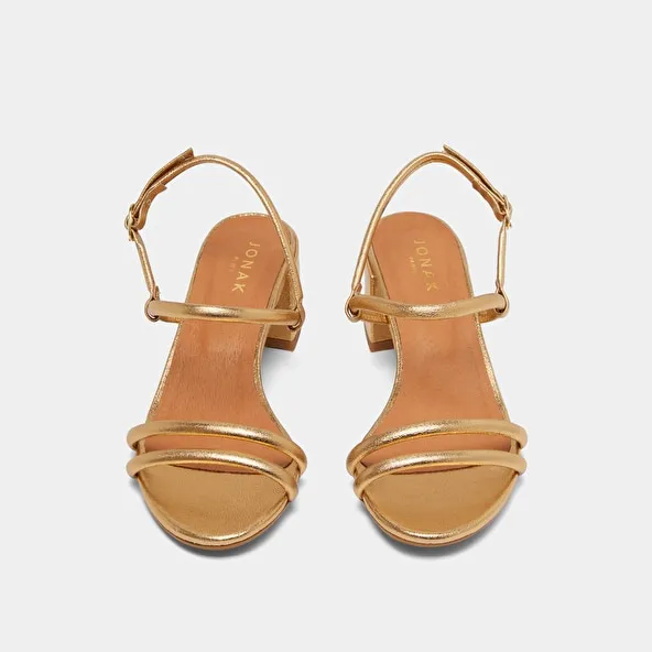 Heeled sandals in gold metallic leather